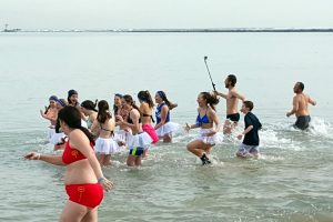 a group of people taking a polar plunge