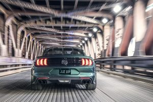rear view of a green 2019 Ford Mustang Bullitt driving through a tunnel