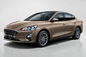 side view of a tan Asian 2019 Ford Focus Sedan
