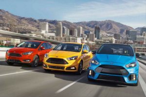 three 2018 Ford Focus models driving down the road side by side