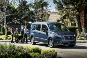 family loading up the back of their blue 2019 Ford Transit Connect Wagon