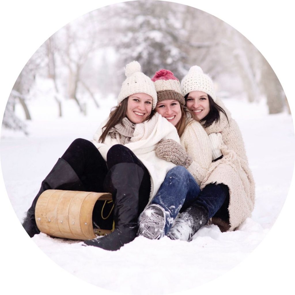 three women on sled
