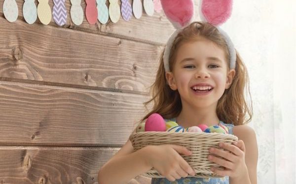 young girl with Easter eggs and bunny ears
