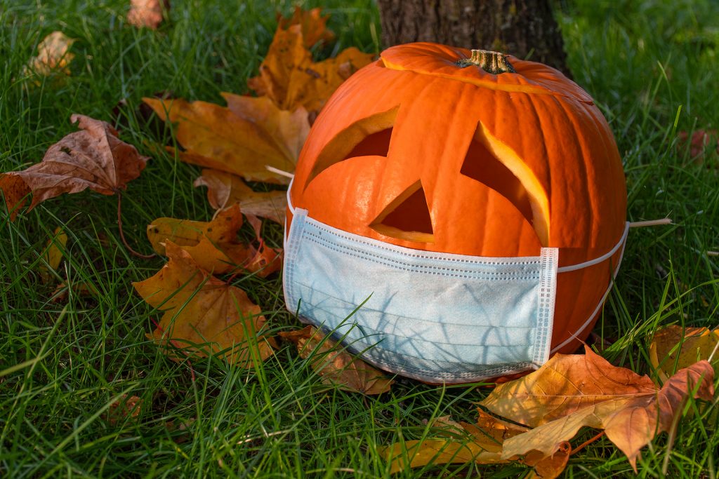 Halloween pumpkin wearing surgical mask