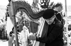 Black and White Image of Irishman Playing a Celtic Harp