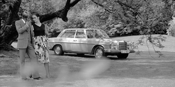 White 1970 Mercedes-Benz 300 SEL in a Park with a Couple