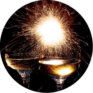 Two Glasses of Champagne and Fireworks on Black Background