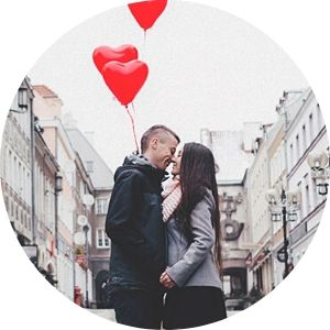 Couple Kissing on a City Street with Red Heart Balloons