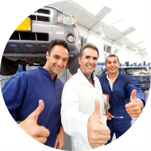 Three Mechanics in a Garage Giving a Thumbs Up
