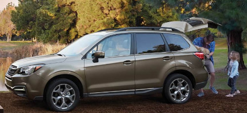 Mother and daughter placing cargo in rear area of 2018 Subaru Forester