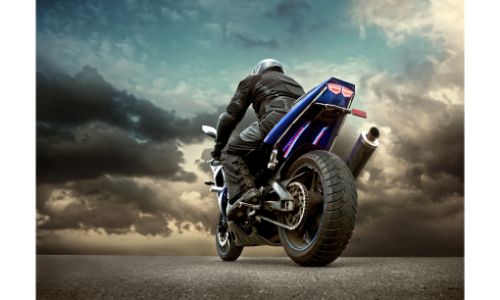 Low angle shot of a man on a motorcycle