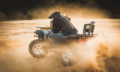 ATV racing through the sand