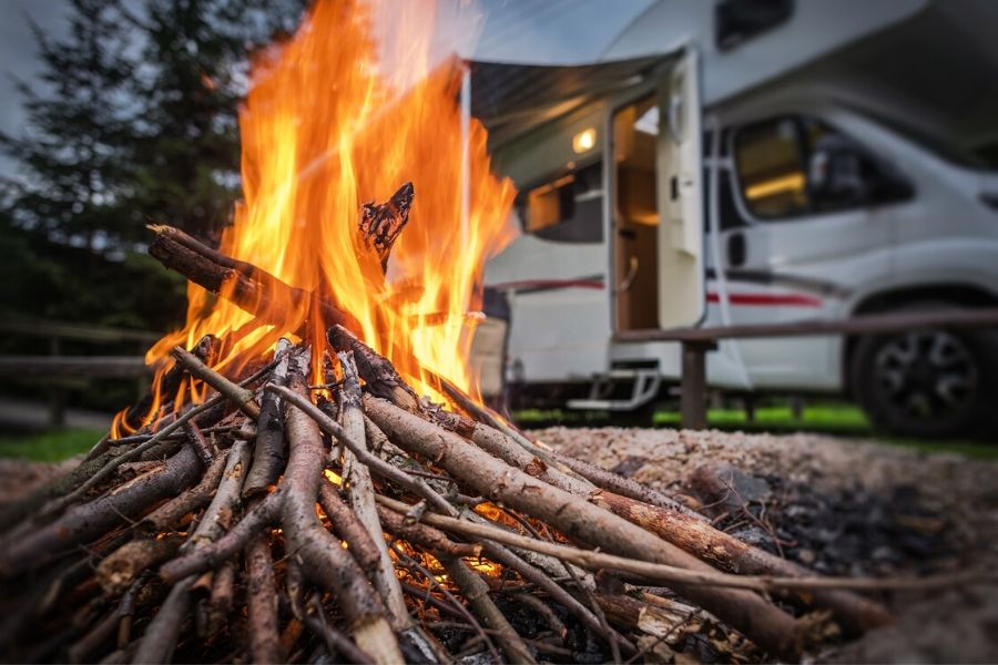Sticks on fire in front of RV
