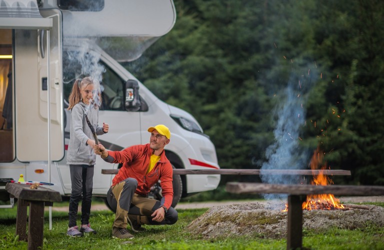 Dad and daughter camping by RV