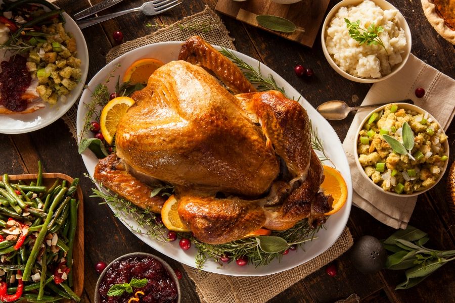 Thanksgiving turkey with side dishes on table