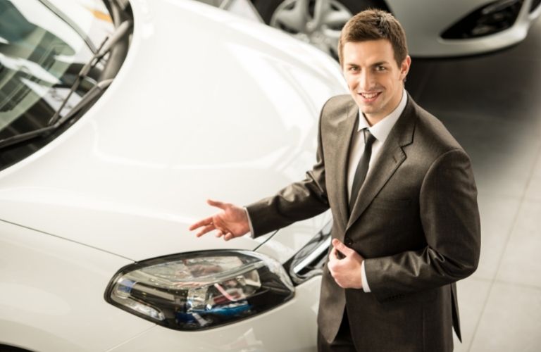 Salesperson showing a car
