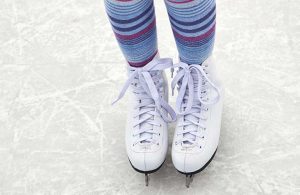 close up of ice skates on ice