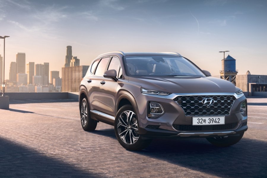 Gray 2020 Hyundai Santa Fe from front passenger view with city skyline in background