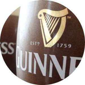Close Up of Guinness Glasses and Guinness Harp Logo