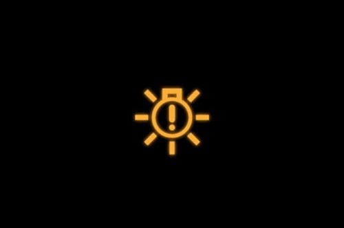 Volkswagen light bulb with exclamation point icon on a black background.