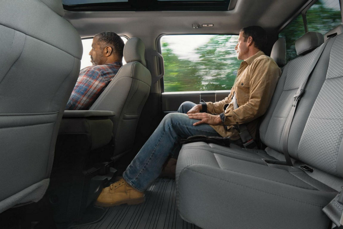 Man sitting comfortably in the rear seat of the 2018 Ford F-150