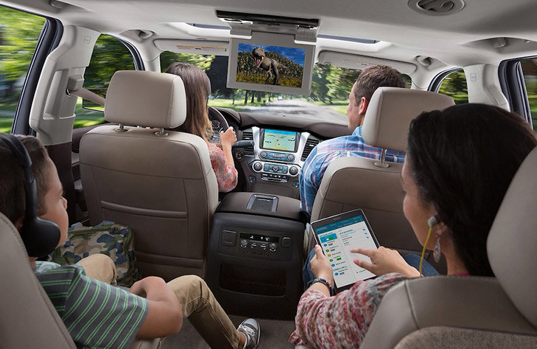 Family sitting in a 2018 Chevy Suburban
