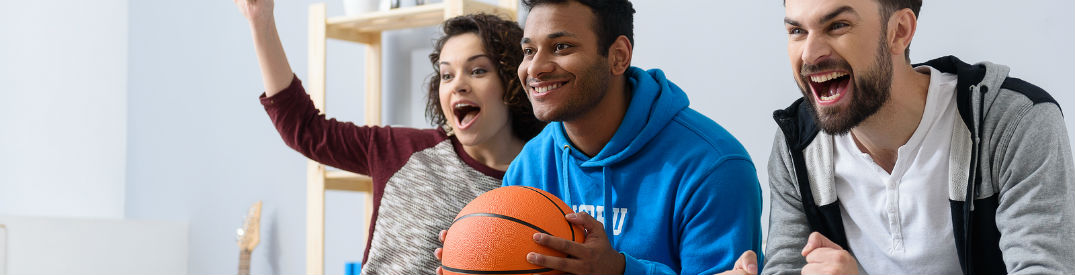 Happy basketball fans watching a game on TV