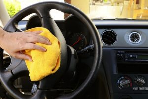 Wiping steering wheel with microfiber towel