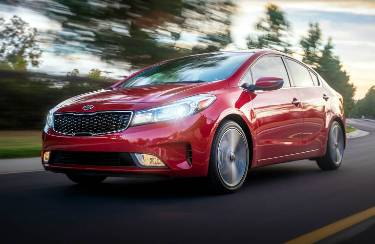 2018 Kia Forte in red driving down the road