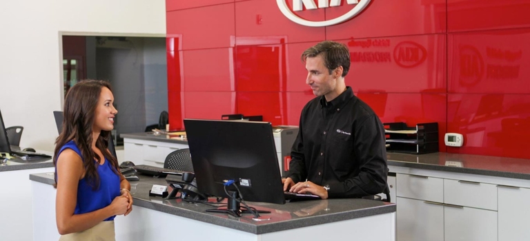 Customer talking to a Kia service rep