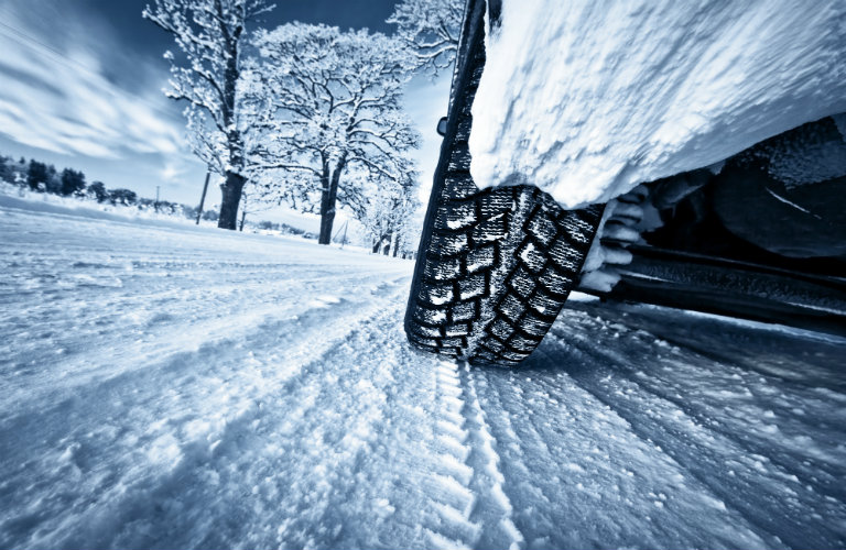 Close-up-of-car-tires-on-winter-road