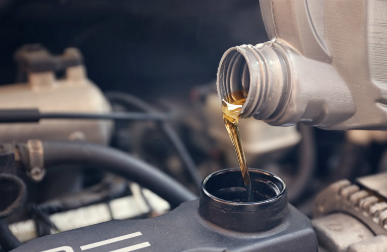 Pouring-new-engine-oil-into-vehicle