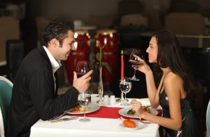 man and woman at fancy dinner table
