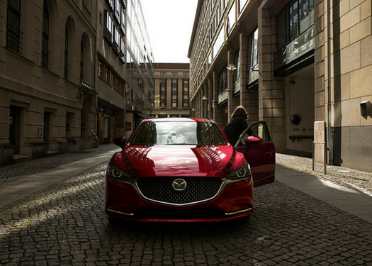 front view of a 2018 Mazda6 with woman getting out of driver door