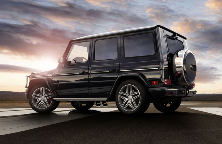 Black Mercedes-Benz G-Class sitting on the road with the sunset