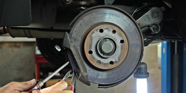 Mechanic Repairing Brakes