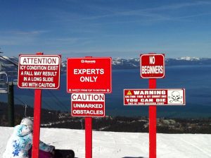 Experts Only signs and Lake Tahoe in background.