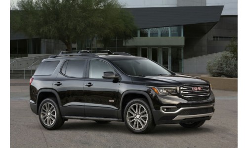2018 GMC Acadia black outside family home with trees