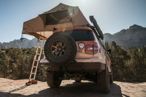 Rear view of Nissan Mountain Patrol with spare tire and ladder in view
