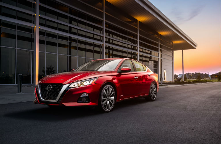 2019 Nissan Altima Edition ONE parked next to a builiding with the sun setting in the background
