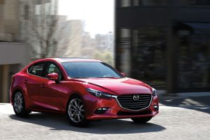 Passenger side exterior view of a red 2018 Mazda3