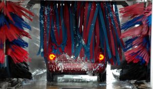 vehicle driving through automatic car wash