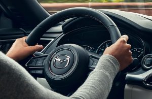 woman driving a Mazda vehicle