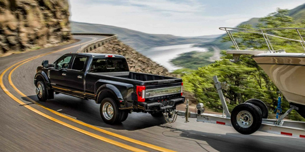 2018 F-250 Super Duty Towing a Boat Up the Road