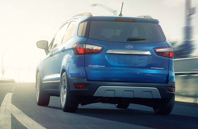 Rear view of blue 2018 Ford EcoSport driving on highway in daytime