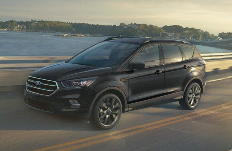 Black 2018 Ford Escape SE driving on waterfront bridge